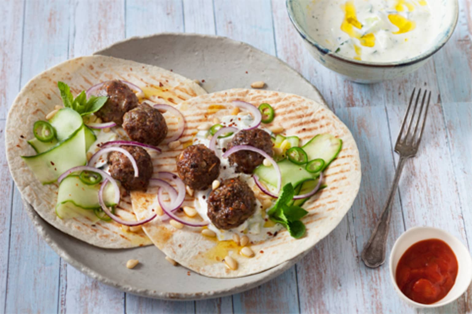 Burritos aux boulettes de bœuf, oignons, pignons de pin, sauce tzatziki